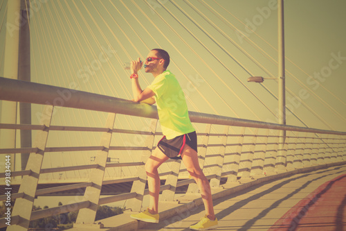 Jogger on a bridge making a pause.