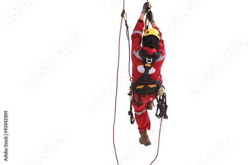 Rope access technician climbing with cable