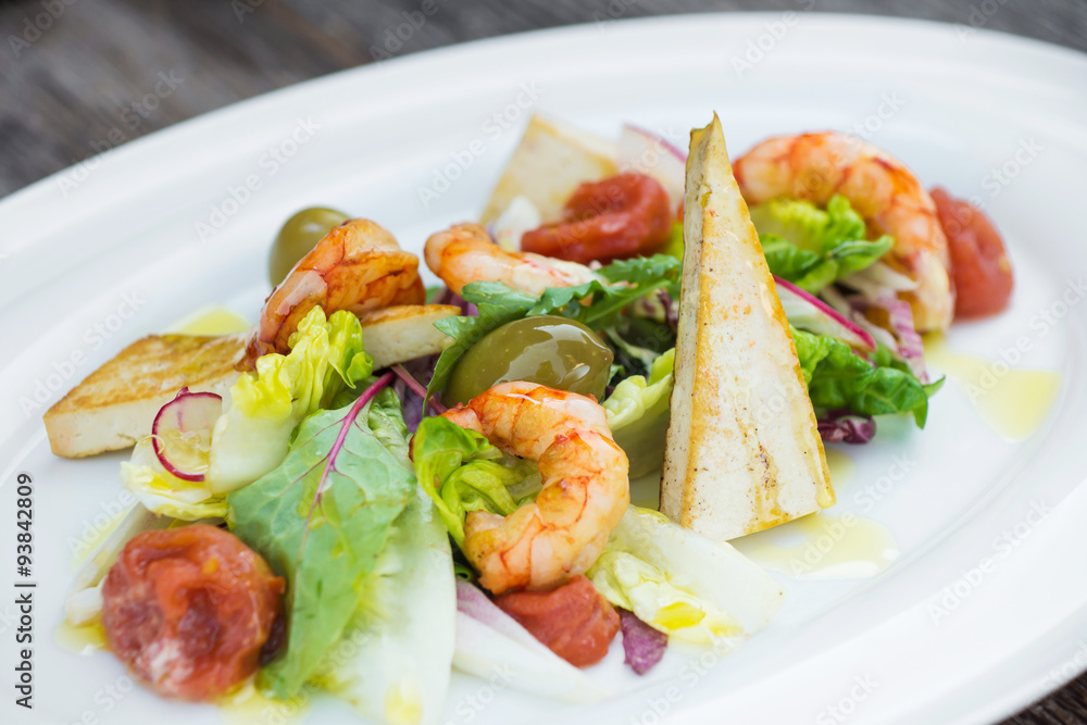 Prawns salad on a wooden background