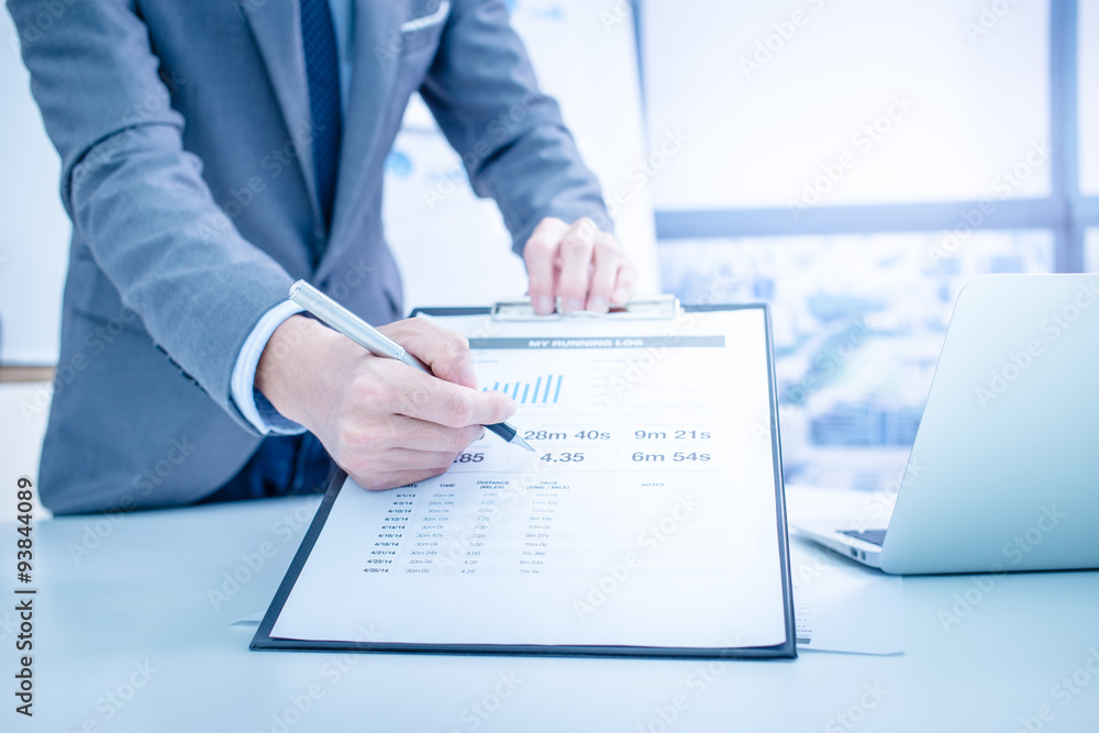 Businessman analyzing investment charts. Accounting Businessman analyzing investment charts. Accounting