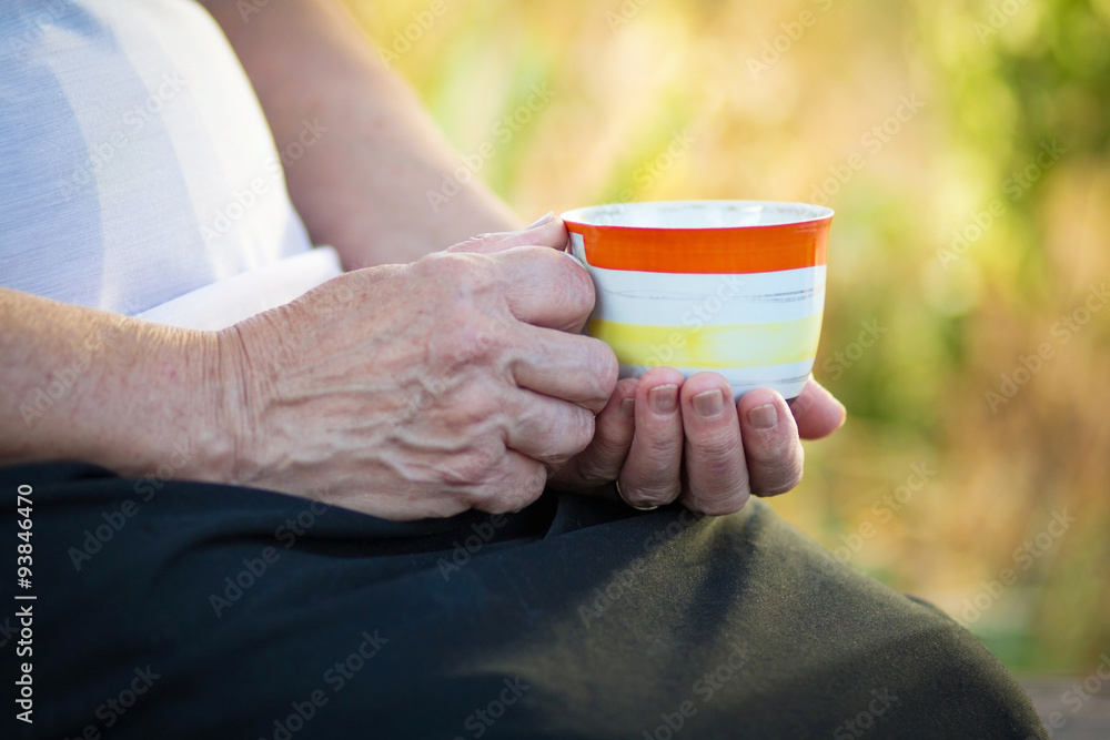 elderly woman with a cup of drink elderly woman with a cup of drink
