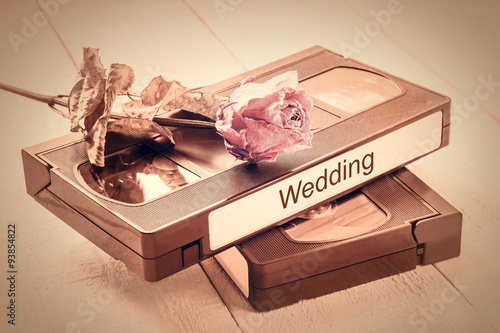 The old video tapes and dried rose. Tinted photos