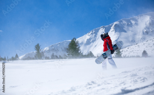 snowboarder against panoramic winter mountains