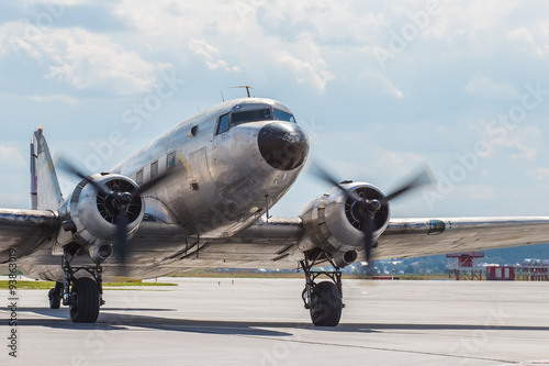 Old plane Douglas 40s taxiing after landing in the parking lot photo