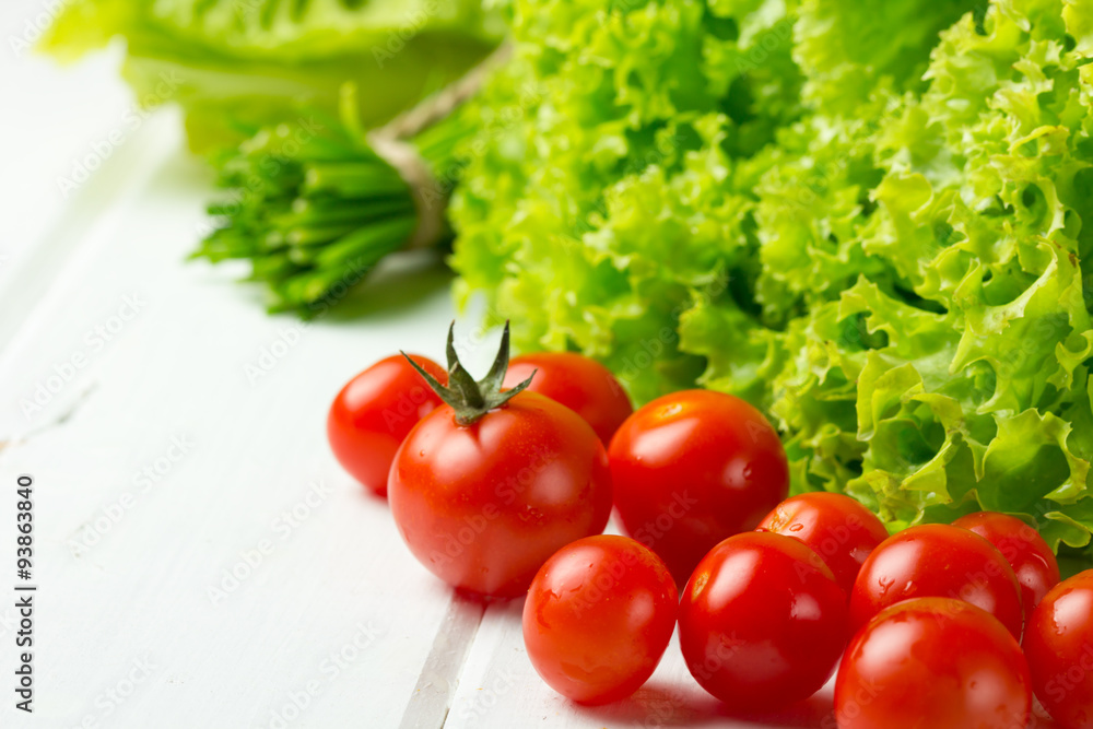 lettuce salad, tomatoes and green onion on white background lettuce salad, tomatoes and green onion on white background