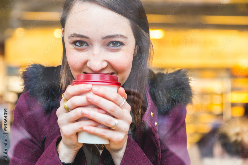Beautiful woman in a cafe holding a cuf of tea Beautiful woman in a cafe holding a cuf of tea