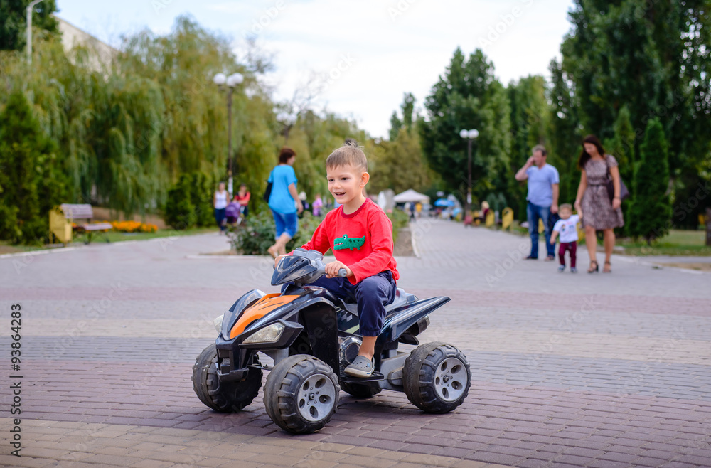 Little boy having fun on a quad bike Little boy having fun on a quad bike