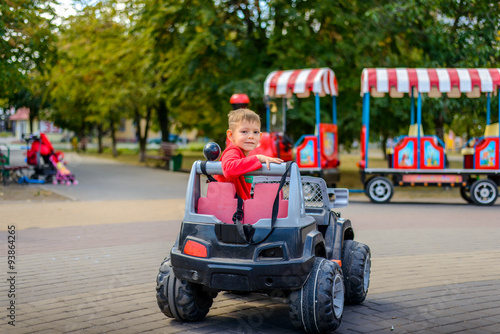 Cute little boy driving a toy truck