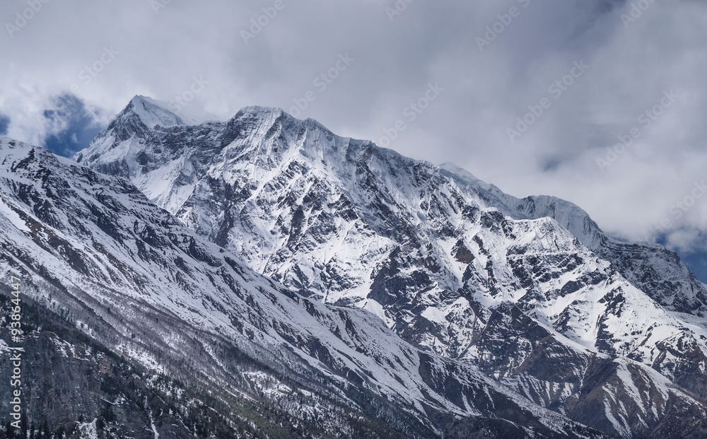 High mountains in the clouds. Beautiful natural landscape in the summer time..