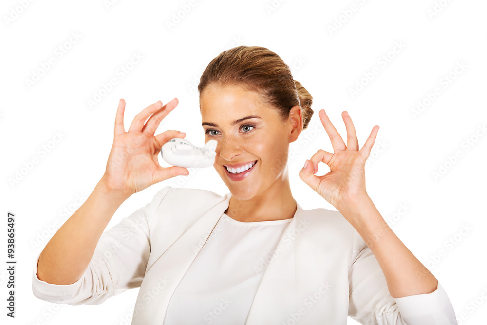 Beautiful businesswoman holding airplane model and shows perfect Beautiful businesswoman holding airplane model and shows perfect