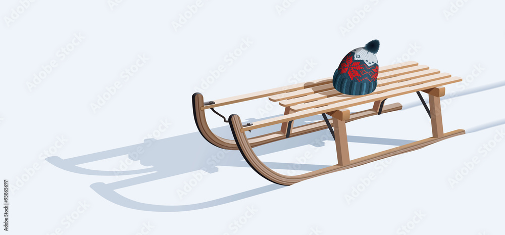 Naklejka premium Wooden sled and hat on snow