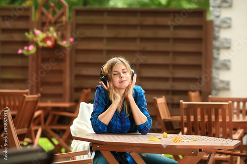 Student girl enjoys listening to music with eyes closed