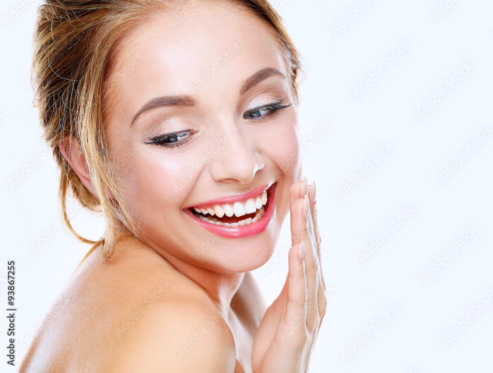 Studio shot of a beautiful young woman with perfect skin against Studio shot of a beautiful young woman with perfect skin against