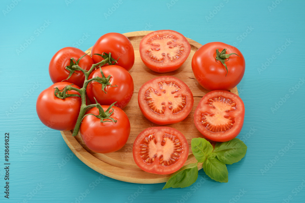 Tomatoes - cut, whole and on the vine with fresh basil Tomatoes - cut, whole and on the vine with fresh basil