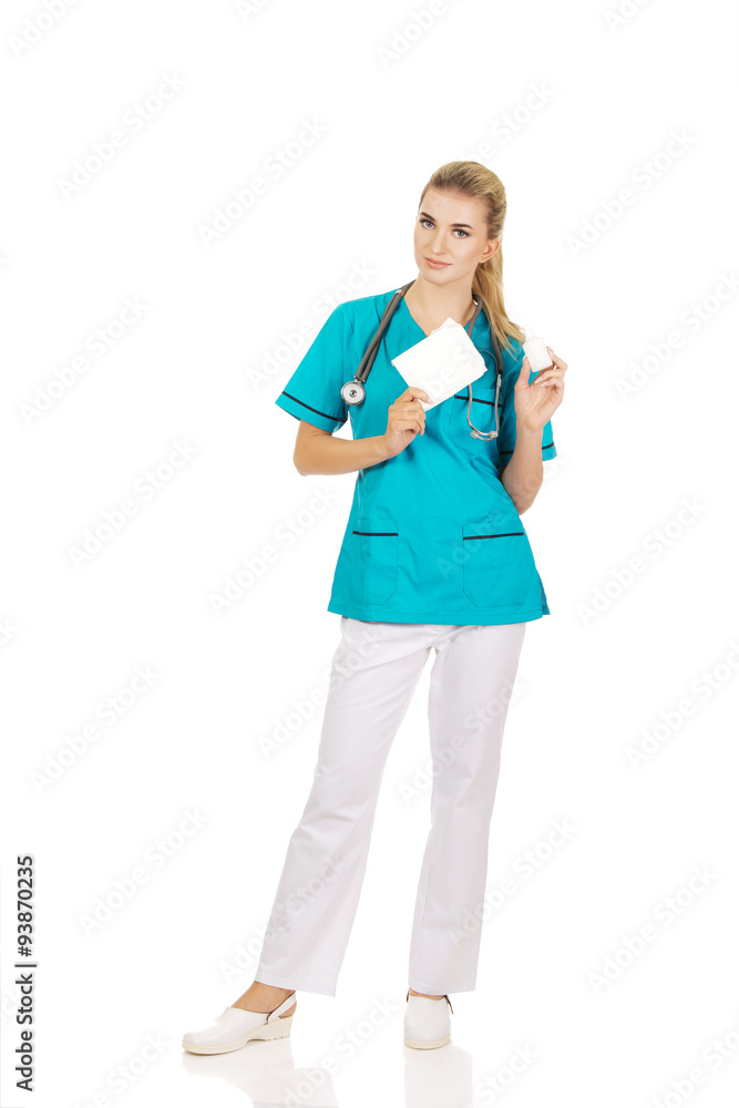 Female nurse holding gauze and hydrogen peroxide Female nurse holding gauze and hydrogen peroxide