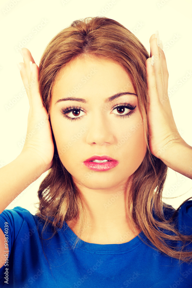 Fototapeta premium Woman covering her ears.