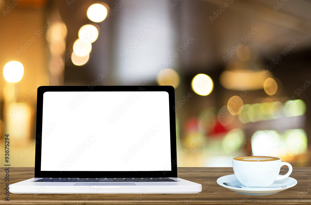 Fototapeta premium laptop with blank white screen and hot coffee latte on a wooden