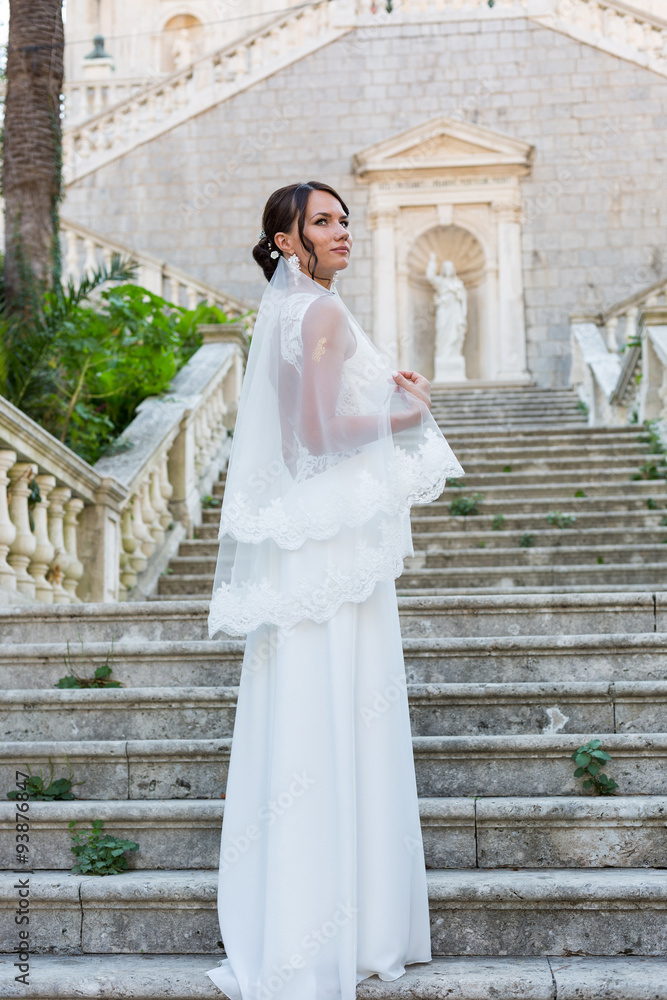 Beautiful bride outdoors posing on the steps
