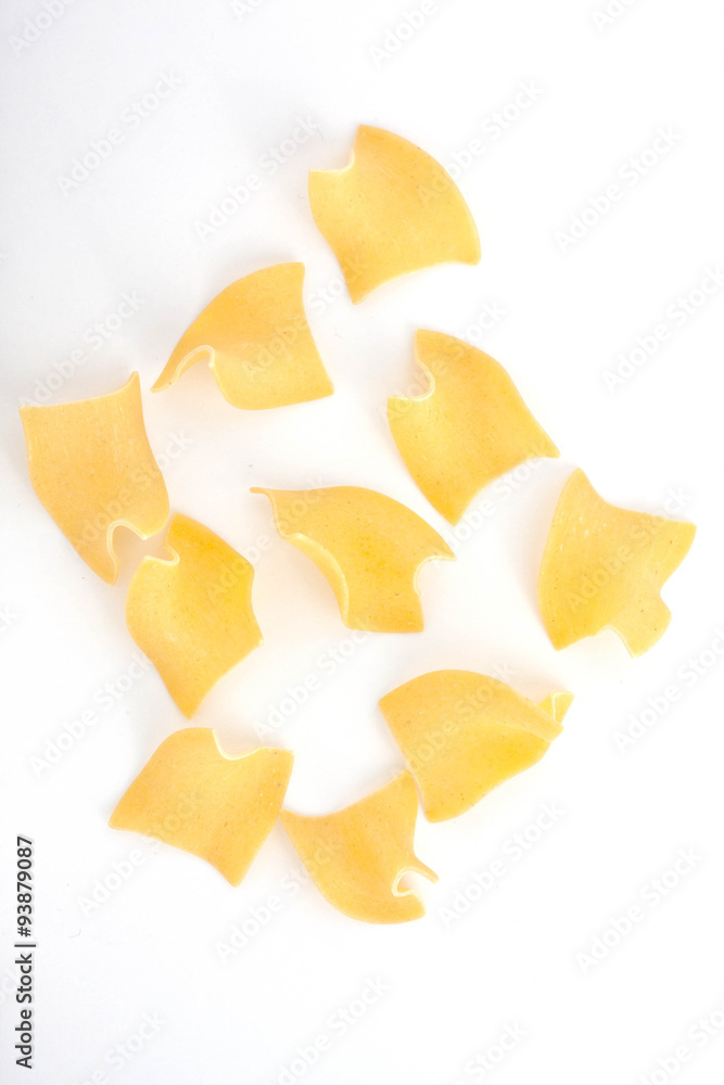 egg noodles pasta scattered on white background egg noodles pasta scattered on white background