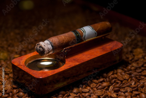 closeup a cigarette in the ashtray on the wooden coffee beans