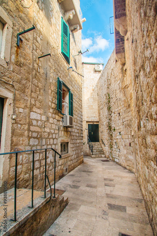 Narrow street and houses walls in the Old Town in Dubrovnik, Croatia