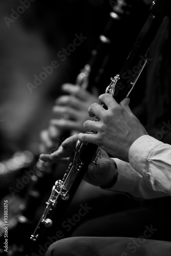 Human hand plays the clarinet in black and white 
