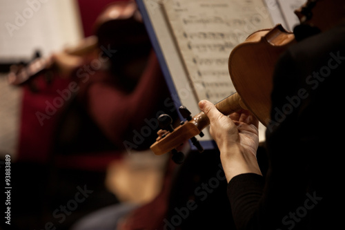 Fragment of a violin in the hands of a musician in a Symphony orchestra