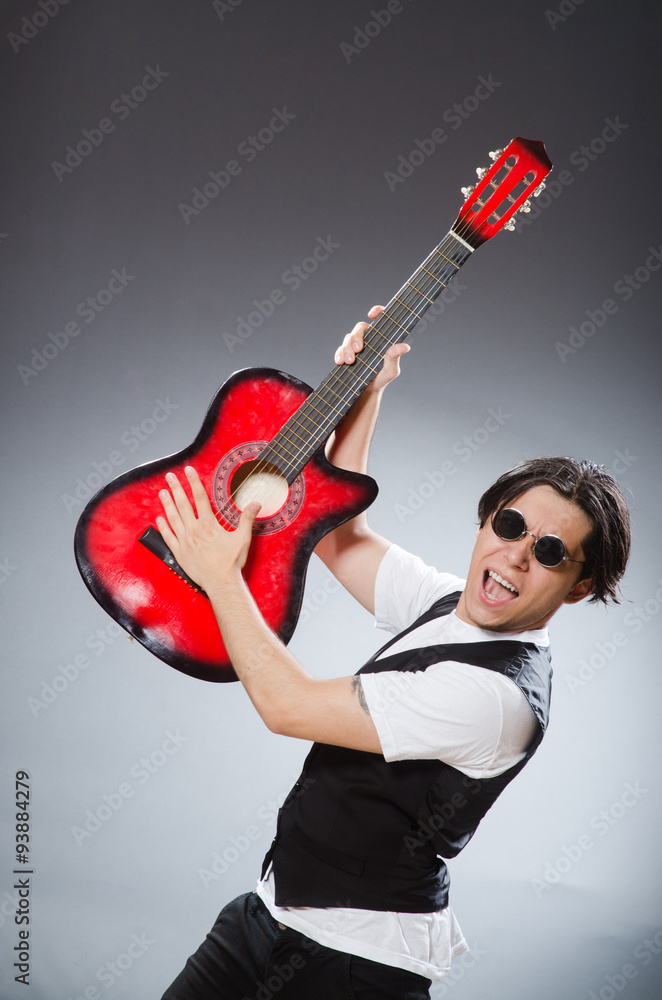 Funny guitar player in musical concept Funny guitar player in musical concept