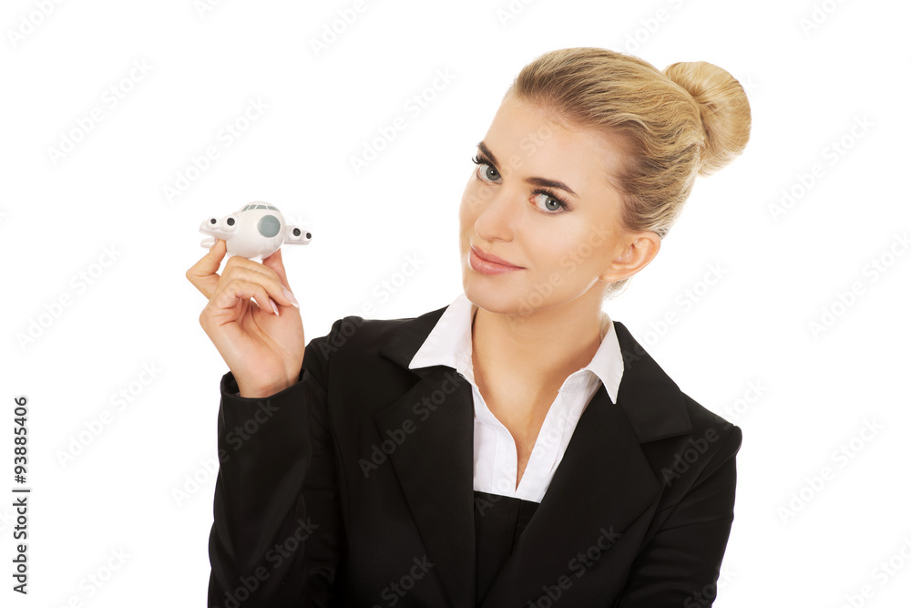 Beautiful businesswoman holding airplane miniature Beautiful businesswoman holding airplane miniature
