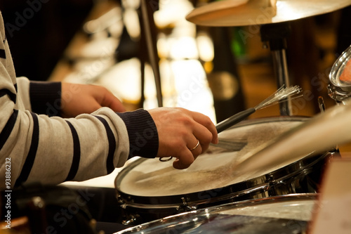 Photography Hands of a man playing a drum set