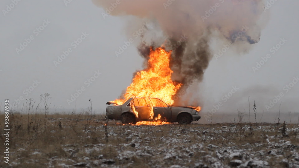 Car explosion on an empty field, side view