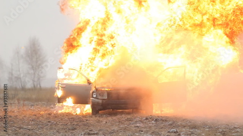 Car explosion on an empty field, slow-mo, front view