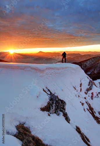 Man on Top with sun in background photo