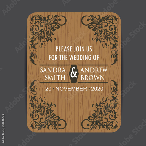 Wooden wedding invitation card with floral elements.

