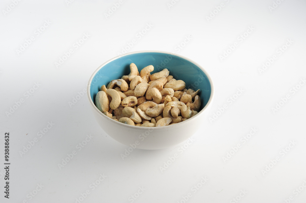 Cashew nuts on bowl on a white background Cashew nuts on bowl on a white background