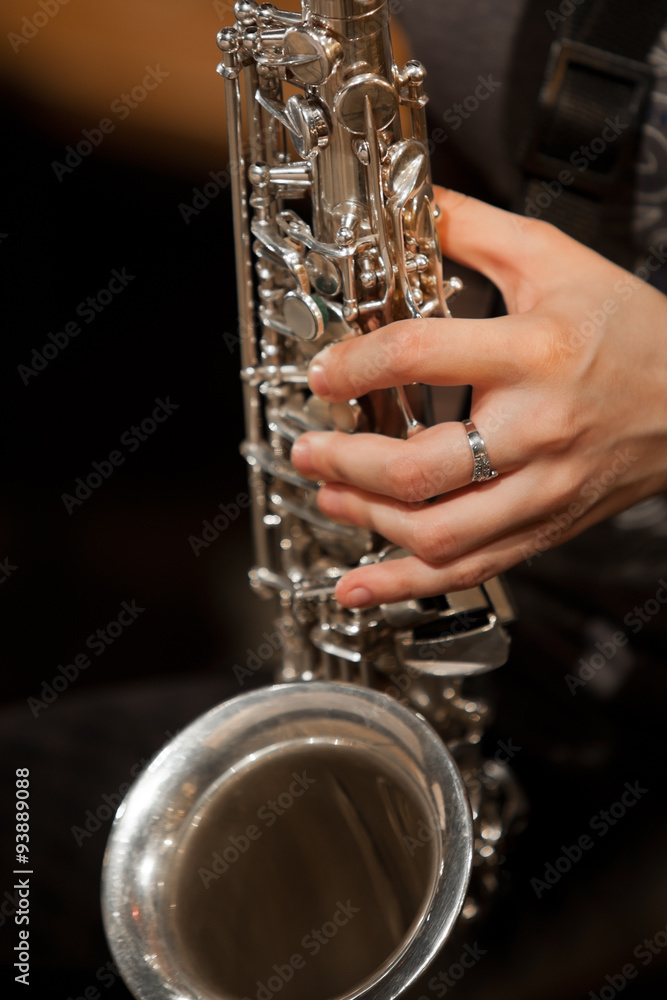 Fototapeta premium Hand girl playing the saxophone