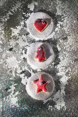 Fototapeta Naklejka Na Ścianę i Meble -  Red Christmas and new year  cookies on shiny background