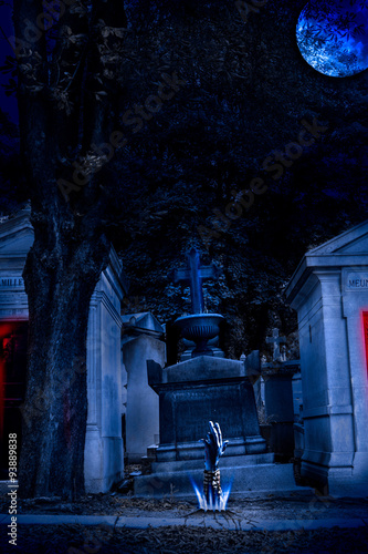 Cemetery Halloween background with graves and zombie hand .