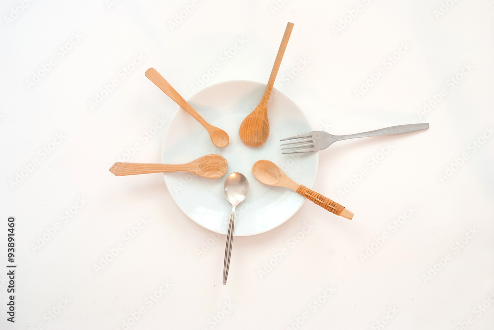 sharing concept - many wooden spoons, one silver spoon and a fork sharing concept - many wooden spoons, one silver spoon and a fork