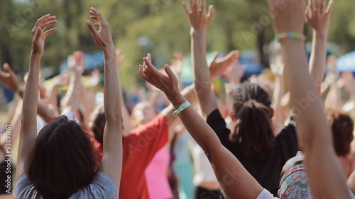 Meditation group of people. Hands reach up