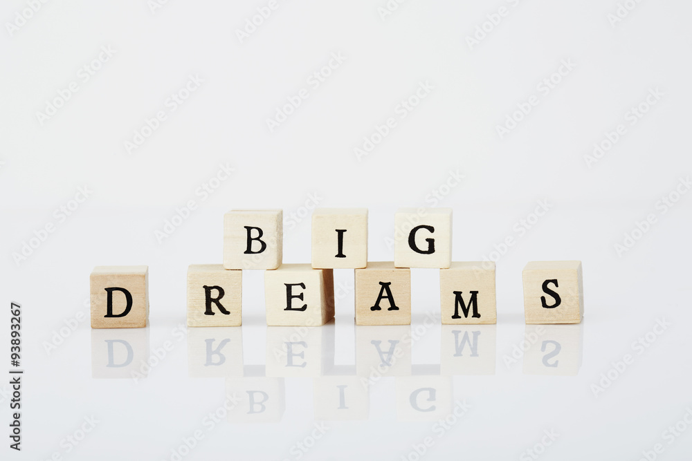 Tiles spelling 'Big dreams' in white studio Tiles spelling 'Big dreams' in white studio