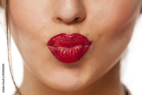 female pursed mouth with red lipstick