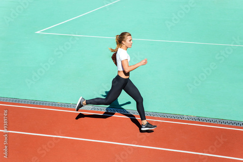 Fitness woman running at stadium © Drobot Dean