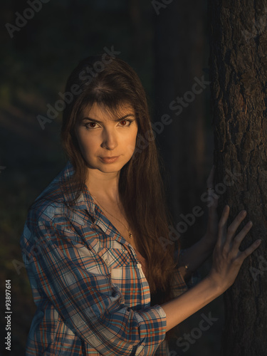 Young girl with long hair in the summer forest