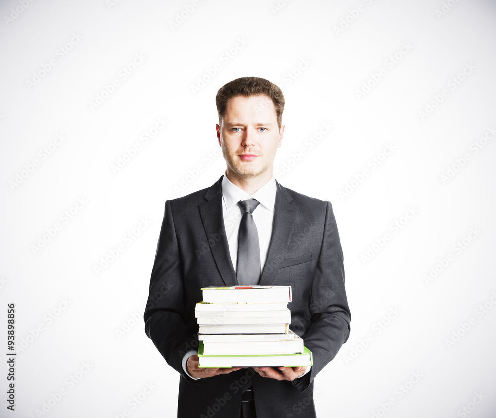 Businessman is caryying books with white background Businessman is caryying books with white background