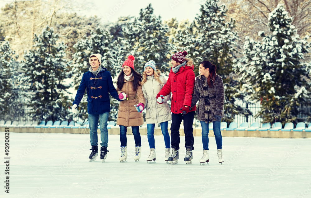 happy friends ice skating on rink outdoors happy friends ice skating on rink outdoors