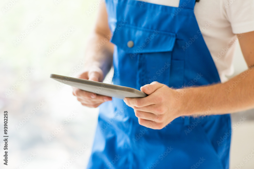 close up of builder or workman with tablet pc