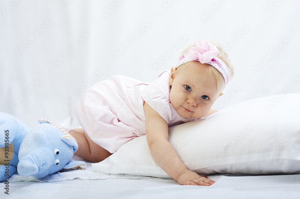 baby is playing with pillow over white background baby is playing with pillow over white background