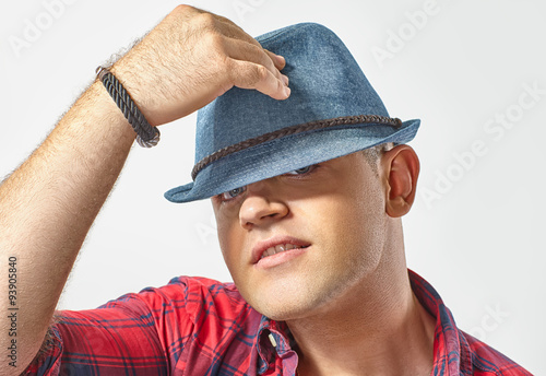 Obraz na plátně Young attractive man wearing a hat