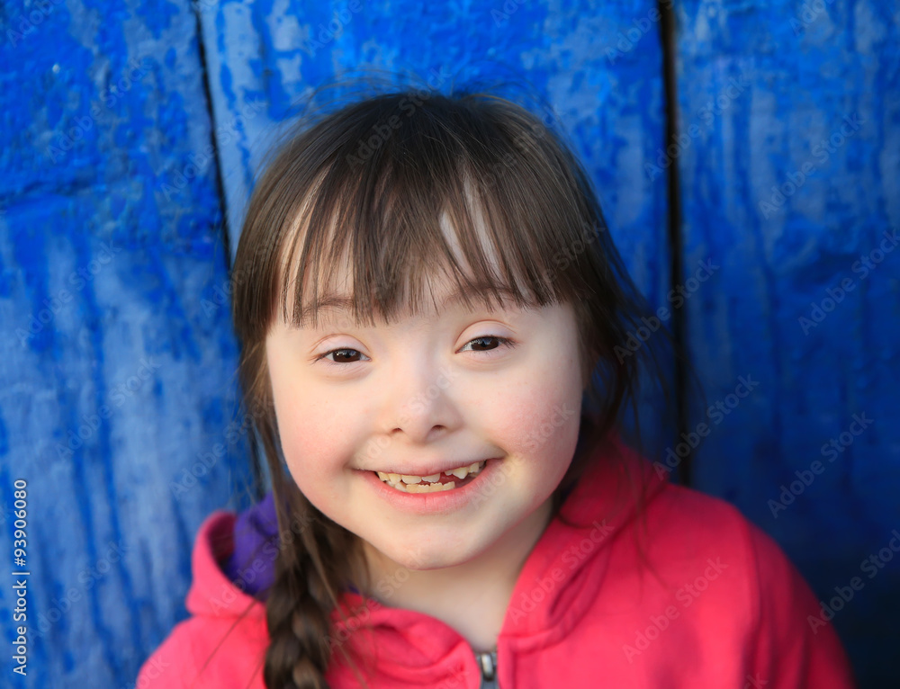 Young girl smiling on background of the blue wall. Young girl smiling on background of the blue wall.